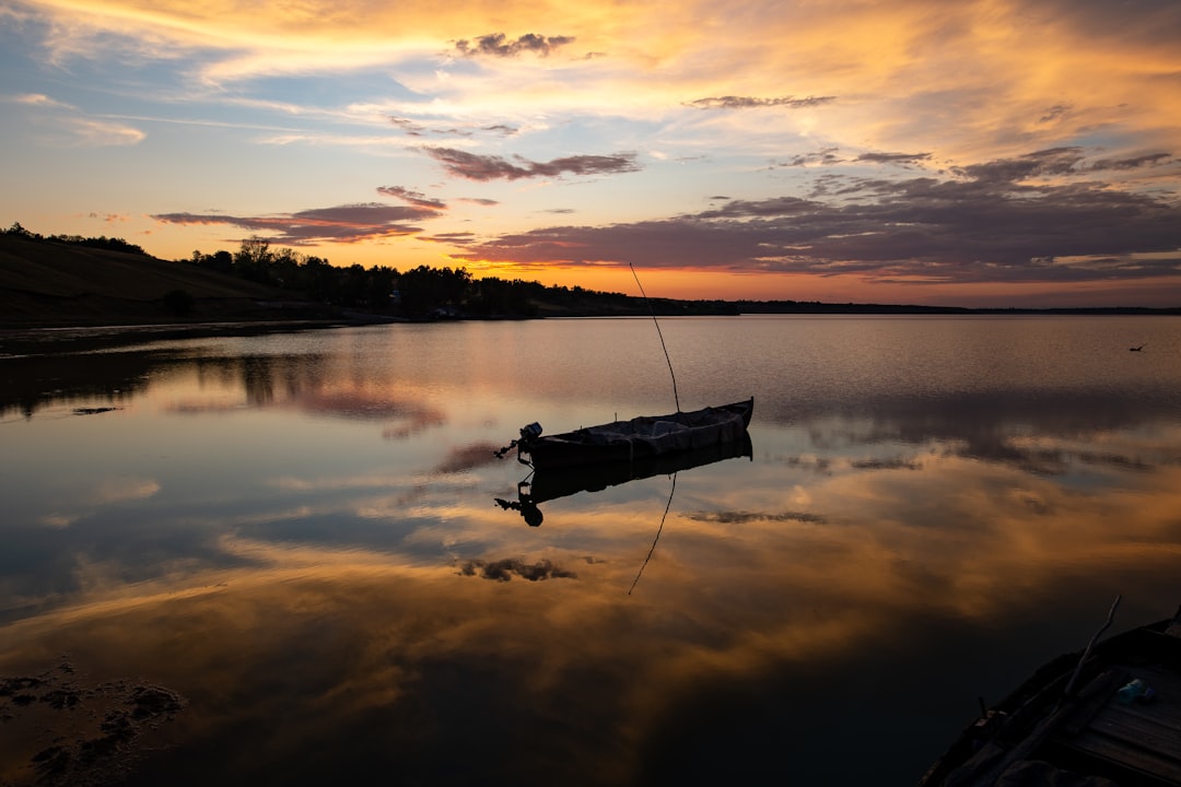 Bass boat on a foggy lake at sunrise